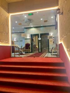 a red staircase in a building with a red carpet at Najmat Alnoor Almaabdah Hotel in Makkah