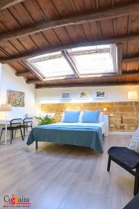 a bedroom with a bed in a room with skylights at B&B Cubbaita in Palermo