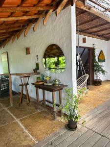 an outdoor room with a table and a wooden table at Jandaia Atins in Atins