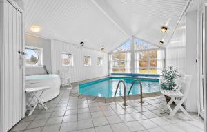 a bathroom with a tub and a swimming pool at Lovely Home In Ebeltoft With Swimming Pool in Ebeltoft