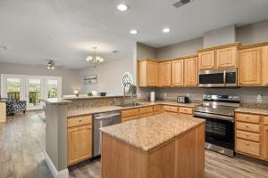 a large kitchen with wooden cabinets and a counter top at Condo #353 in Branson