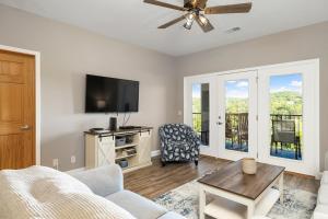a living room with a tv and a couch at Condo #353 in Branson