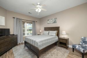 a bedroom with a bed and a tv and a chair at Condo #353 in Branson