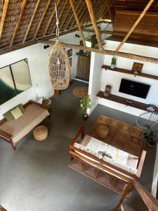 an overhead view of a living room with benches and a tv at Jandaia Atins in Atins