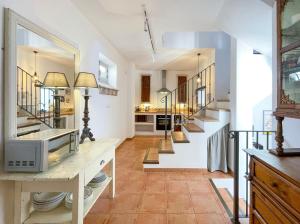 a kitchen with a staircase and a living room at Stunning Spanish white village home Private pool Stunning Views in Saleres