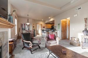a living room with two chairs and a table at Foxpoint 1678C by Moose Management in Park City
