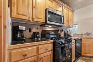 a kitchen with wooden cabinets and a stove and microwave at Foxpoint 1678C by Moose Management in Park City +48 photos