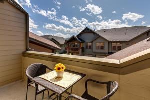 a table and chairs on a balcony with a vase of flowers at Foxpoint 1684-H3 by Moose Management in Park City