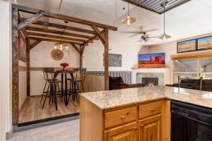 a kitchen and living room with a table and chairs at Foxpoint 1684-H3 by Moose Management in Park City