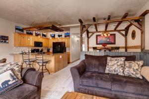 a living room with two couches and a kitchen at Foxpoint 1684-H3 by Moose Management in Park City