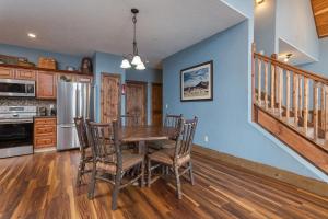 a kitchen with a table and chairs and a refrigerator at Lodge 17 in Branson