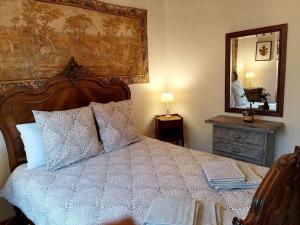 a bedroom with a large bed and a mirror at Brittany France 2 Beds Free Wi-Fi - Parking & Garden in La Haye