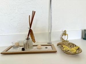 a vase with sticks in it sitting on a counter at La Kawannaise Blue Lagon - Wifi, Plage, Terrasse in Grand-Bourg +11 photos