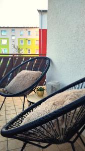 two chairs with a pillow sitting on a balcony at Bright, Modern and Spacious - Apartment "Lola" Family & Workplace in Gießen