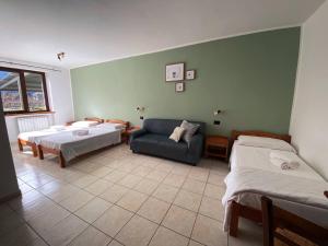 a living room with two beds and a couch at Agriturismo San Giuliano dei fratelli Giai in Susa