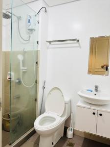 a bathroom with a toilet and a shower and a sink at Loft-Style Condo @ Avida Towers with Wifi in Davao City