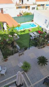 an overhead view of a backyard with a swimming pool at 3 bedrooms apartement with city view shared pool and enclosed garden at Feijo 5 km away from the beach in Almada