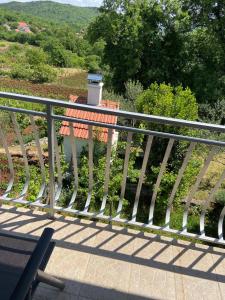 a metal railing on a balcony with a trash can at Holiday home Gudelj in Imotski