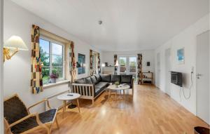 a living room with a couch and a table at Stunning Home In Rm With Wifi in Rømø Kirkeby
