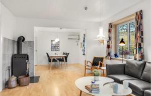 a living room with a couch and a table at Stunning Home In Rm With Wifi in Rømø Kirkeby