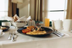 a table with a plate of food on a table at Holiday Inn Abu Dhabi by IHG in Abu Dhabi