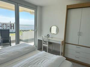 una camera con letto, scrivania e finestra di Seelord 53 (Meloh) a Norderney