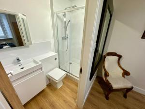 a bathroom with a shower and a toilet and a sink at Struan House in Blairgowrie