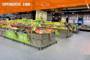 a produce section of a supermarket with fruits and vegetables at La Maison De Pierre in Langeac