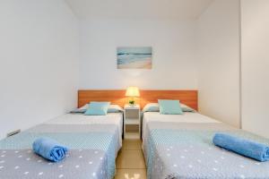 Dos camas con almohadas azules en una habitación. en Mileni 2 1 3 1 Roses - Immo Barneda, en Roses 39 fotos más