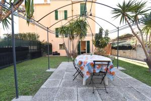 un tavolo e sedie in un cortile con una casa di Welcome Varigotti - Civico53 a Varigotti