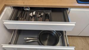a drawer with a pot and utensils in a kitchen at Kaufbeuren mit Wintergarten in Kaufbeuren