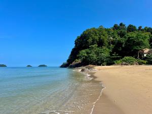 a sandy beach with trees and the ocean at Beach Jungle in Ko Chang