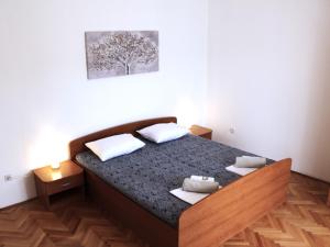 a bedroom with a bed in a room at Family apartments Jimmy - city center in Pag