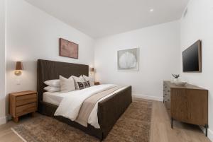 a bedroom with a large bed and a television at The Inn At Anatega #2 in Santa Barbara