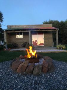 a fire pit in front of a house at La Cabaña Punta Negra in Punta Colorada