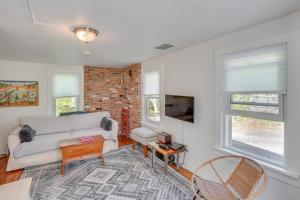 a living room with a couch and a tv at UpdatedandPet-Friendly Cabin By Hikes and Woodstock! in Bearsville
