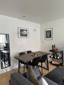 a living room with a wooden table and chairs at Cozy Bedroom in Søborg