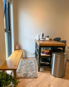 a kitchen with a table and a trash can at Luxury studio with balcony in Reykjavík