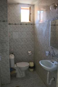 a bathroom with a toilet and a sink at Guest House Elit in Burgas