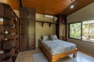 a bedroom with a bed and a window at Casa Cabo Blanco Mal Pais in Carmen +2 photos