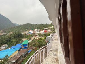 a view of a city from a balcony of a building at hotel holy spirit, sitapur in Sonprayag +2 photos
