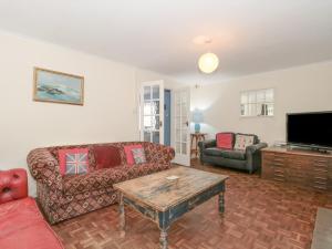 a living room with a couch and a coffee table at The Cottage in Watchet