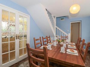 a dining room with a wooden table and chairs at The Cottage in Watchet
