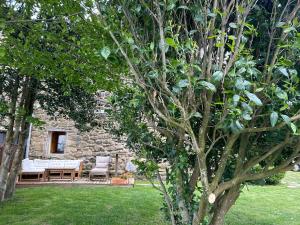 a garden with a table and chairs and trees at Golindo Goikoa in Getaria
