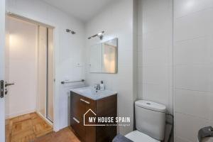a bathroom with a toilet and a sink and a mirror at MyHouseSpain - Tranquilo piso cerca de Sol in Madrid