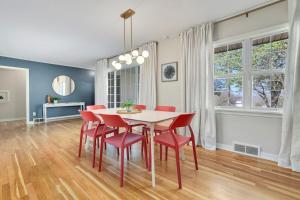 a dining room with a table and red chairs at Fayetteville Flashback 2 Mi to Downtown in Fayetteville