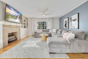 a living room with a couch and a fireplace at Fayetteville Flashback 2 Mi to Downtown in Fayetteville