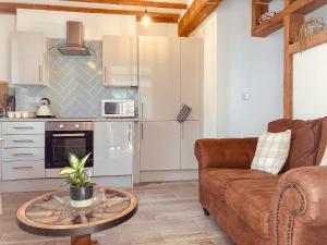 a living room with a couch and a table at Shoreline in Goodrington