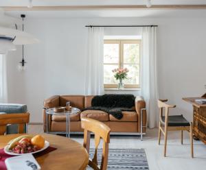 a living room with a couch and a table at Haus Herzogstand - Ferienwohnungen in Kochel am See in Kochel