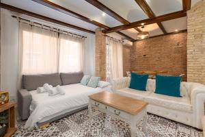 ein Wohnzimmer mit einem Sofa und einem Tisch in der Unterkunft My Loft 4 You Sorolla in Valencia
